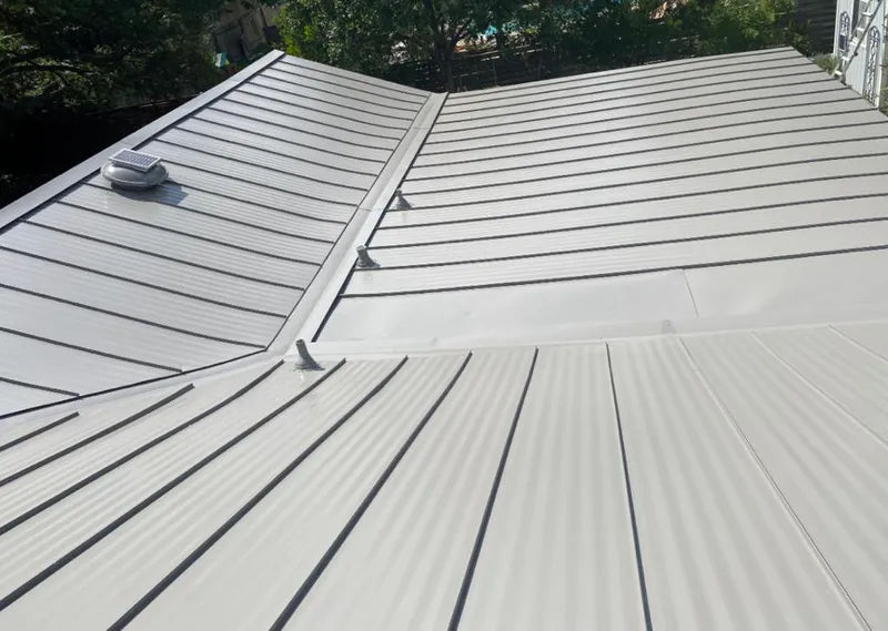 Solar attic fan installed on a metal roof for Roof Ventilation in Allen Park